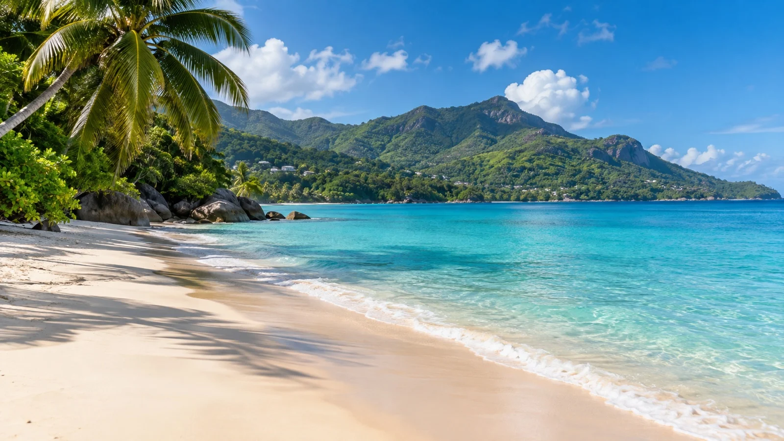 Empty Beau Vallon Beach on Mahé with tropical mountains