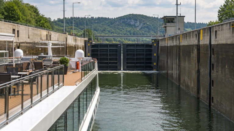 a European river cruise ship inside a modern concrete lock chamber on the Main-Danube Canal in Bavaria