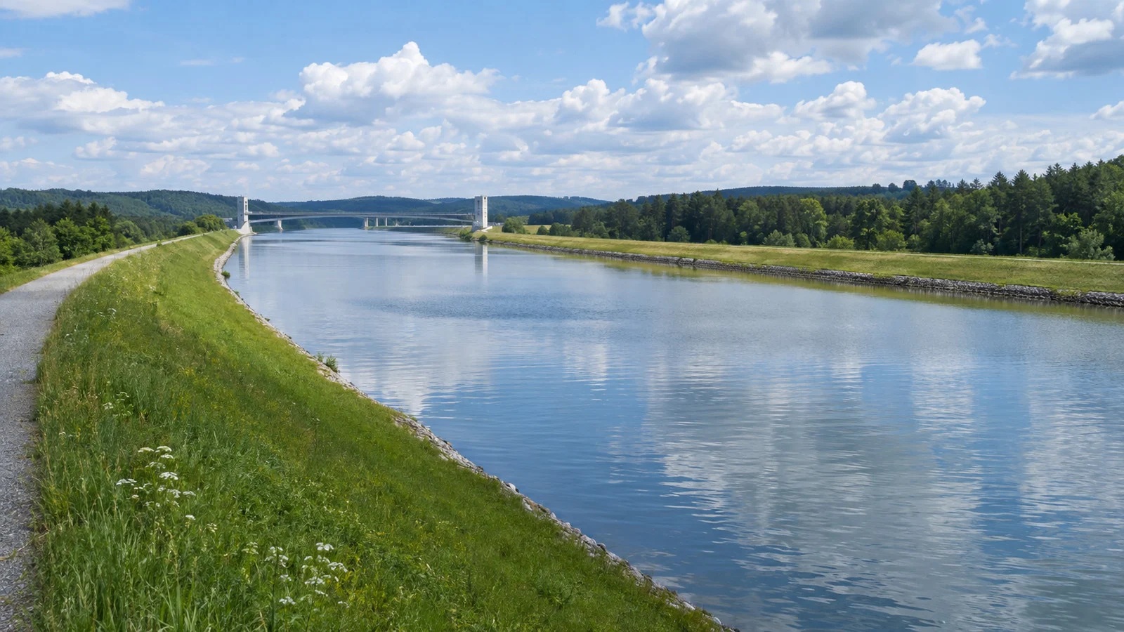 the Main-Danube Canal at its high watershed crossing in Bavaria with flat waterway and green embankments