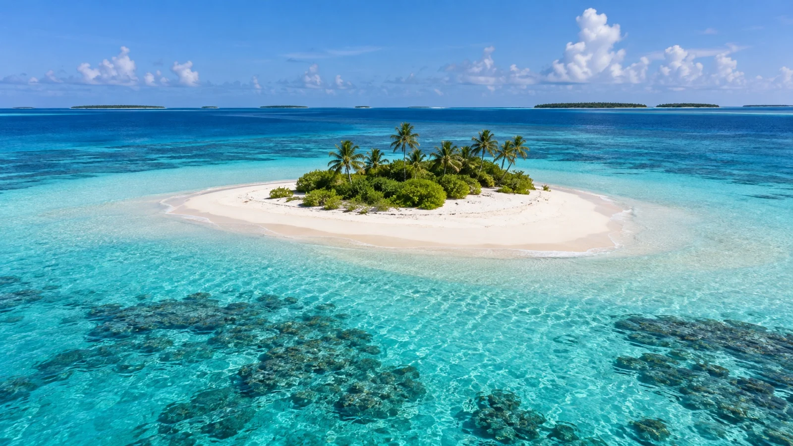 Uninhabited sandbank surrounded by clear Maldivian lagoon