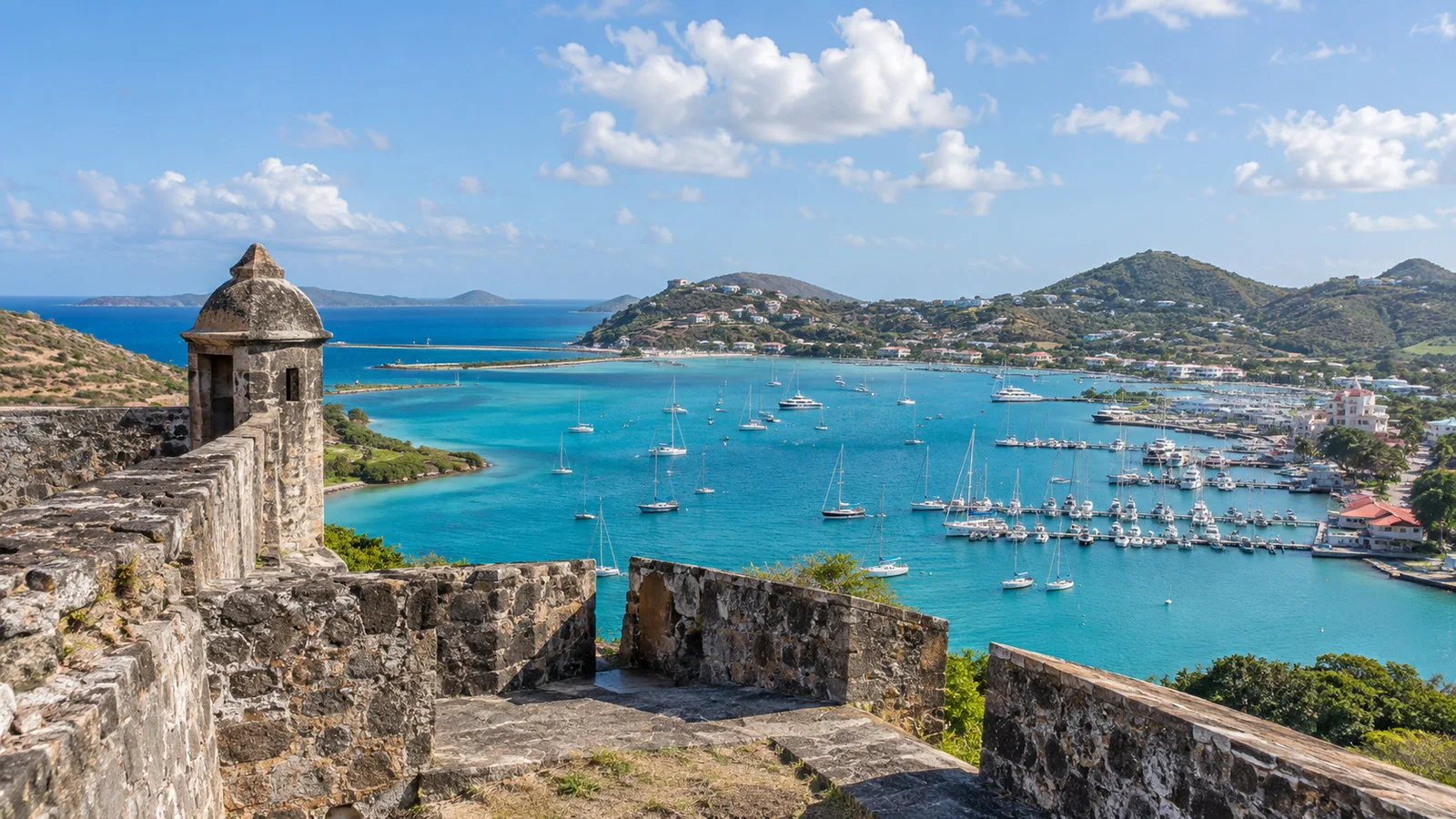 Fort Louis ruins above Marigot Bay Saint Martin with stone walls, turquoise water and marina panorama, no people