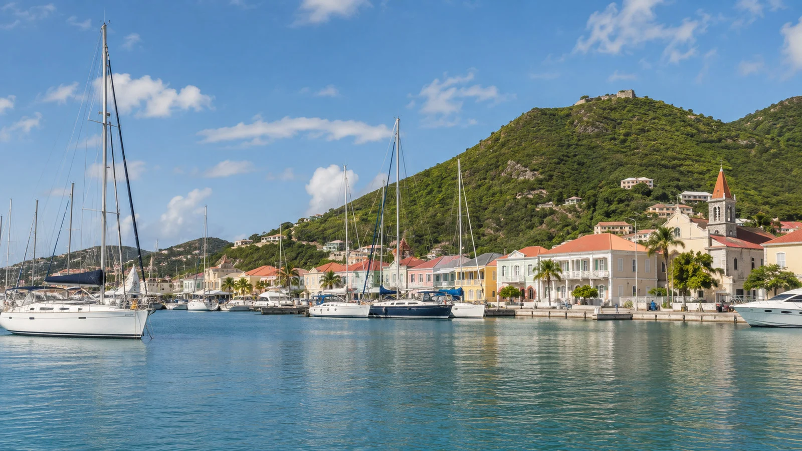 Marigot marina Saint Martin with sailboats and pastel French Caribbean waterfront buildings, no people