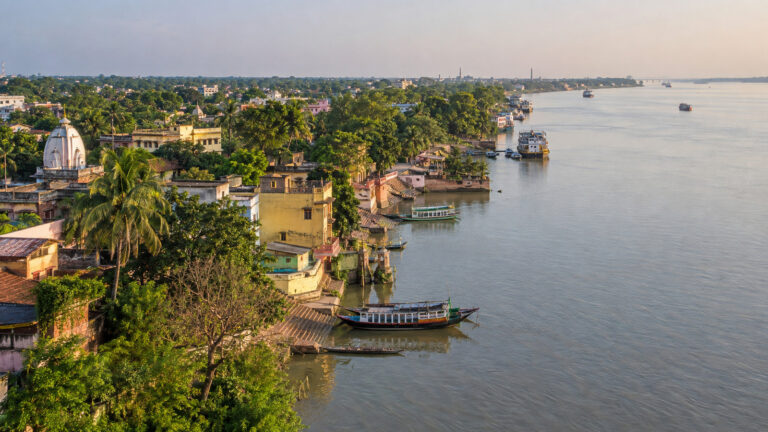 Aerial view of Matiari village beside the Hooghly River with boats along the riverbank