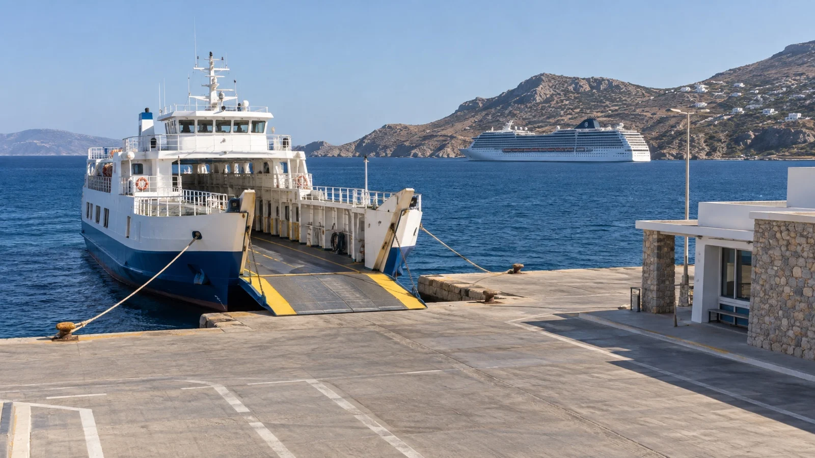 Empty Mediterranean island ferry terminal with ferry and cruise ship offshore