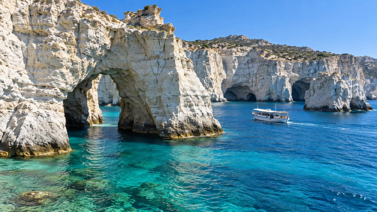 White sea arches and a small boat at Kleftiko on Milos