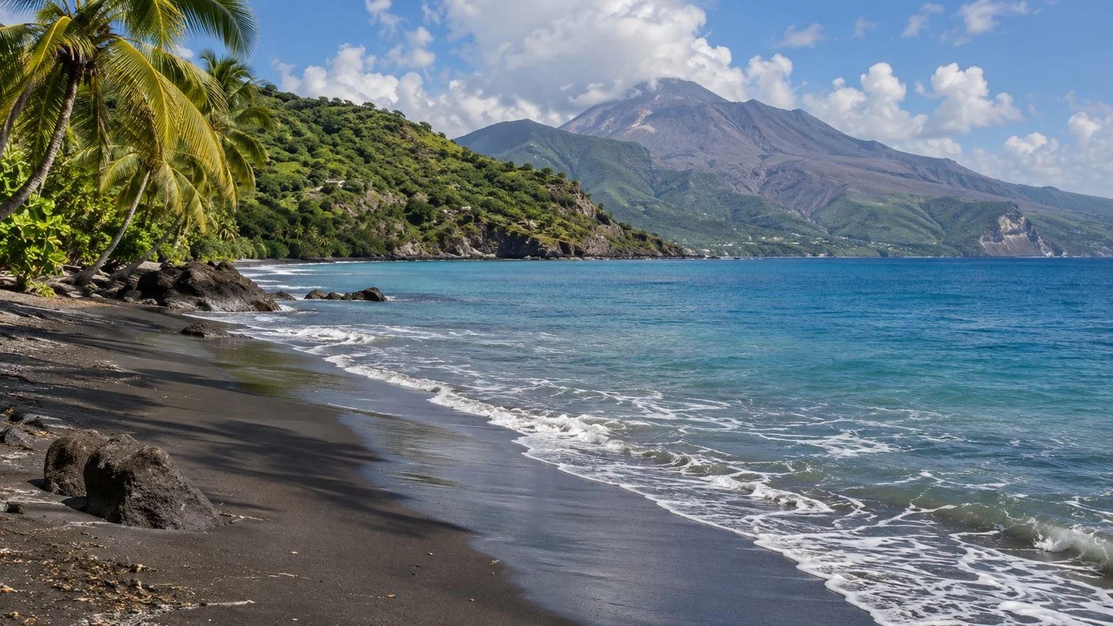 Dark volcanic sand beach and green coast in Montserrat