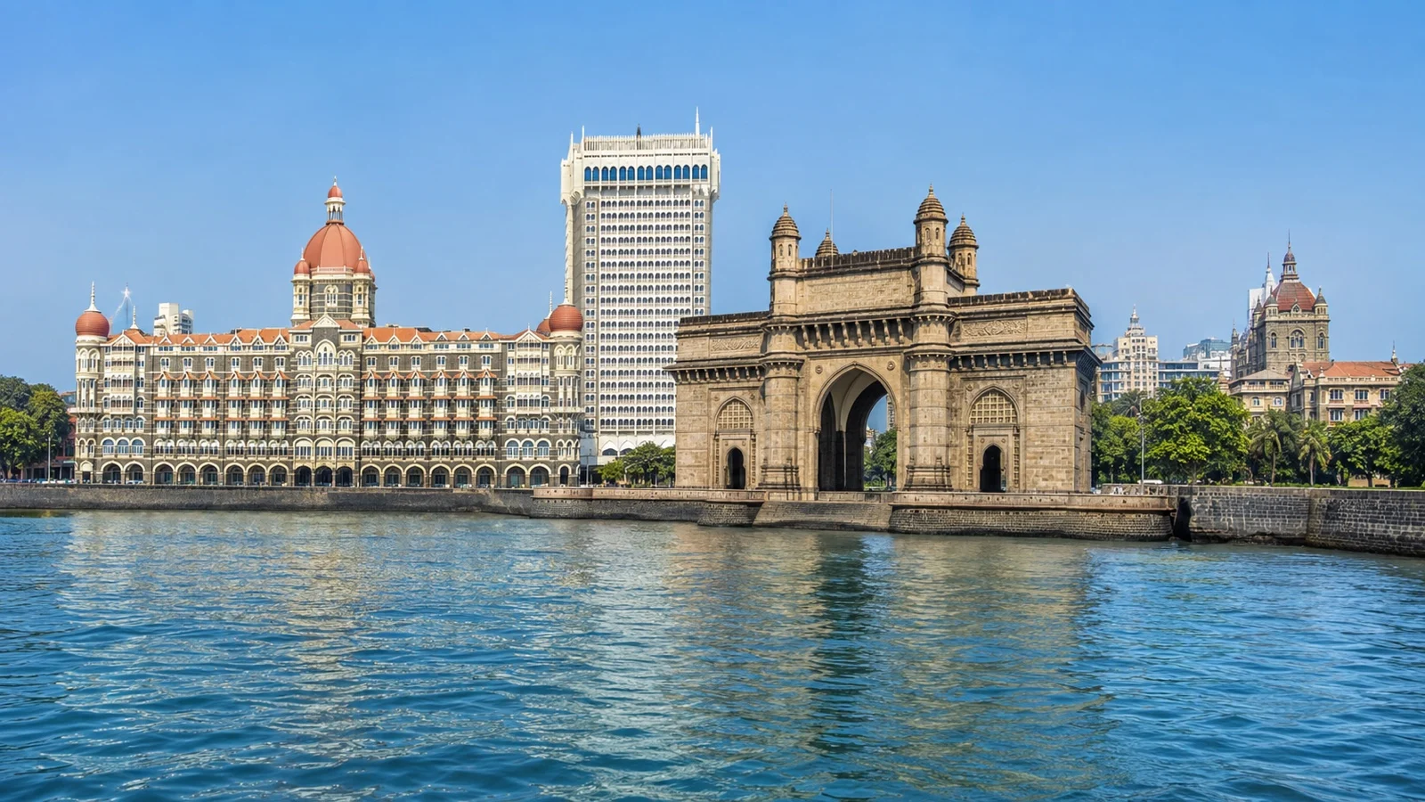 Panoramic South Mumbai waterfront showing the Gateway of India, heritage buildings and blue harbor water