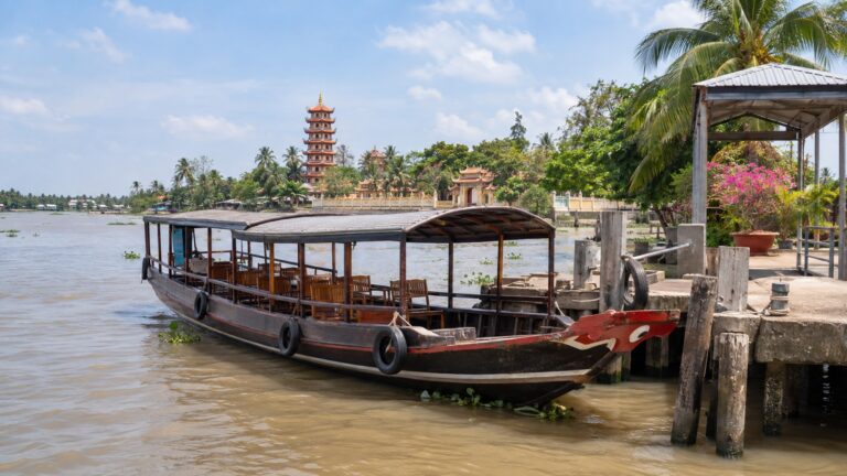 Covered wooden excursion boat at a Mekong landing near My Tho