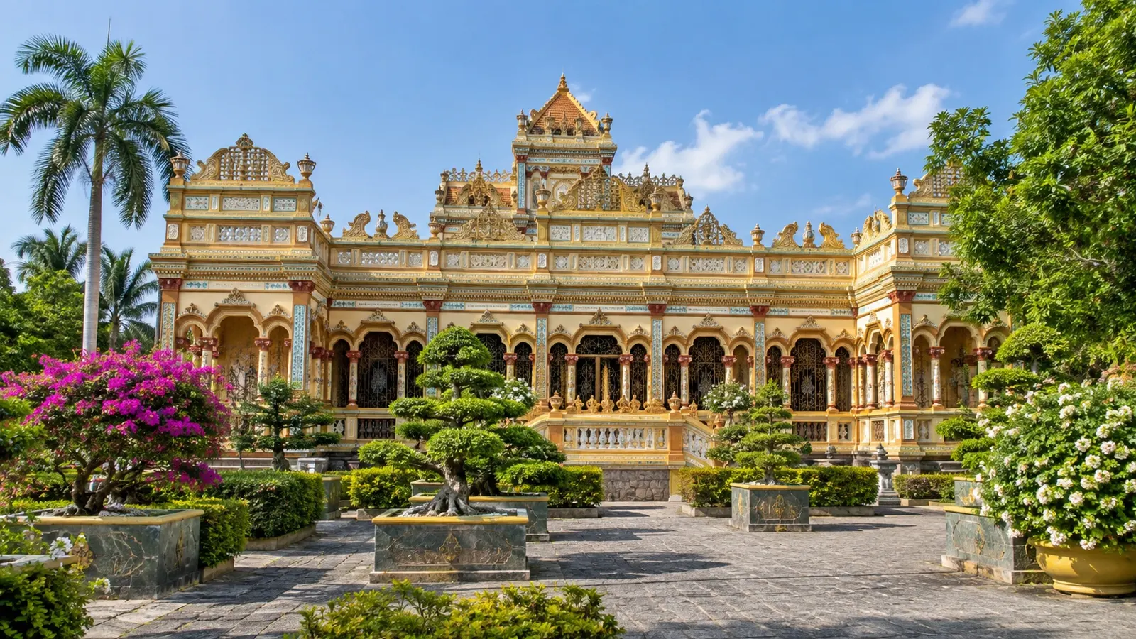 Ornate facade and garden of Vinh Trang Pagoda in My Tho, Vietnam