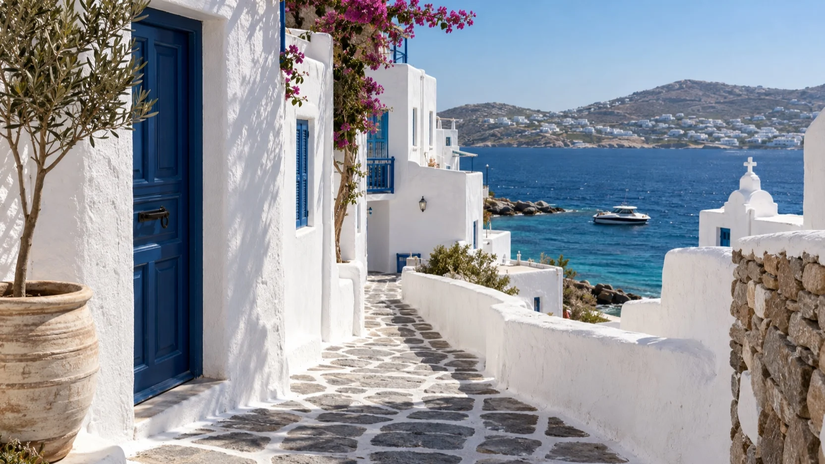 Empty whitewashed Mykonos lane above the Aegean Sea