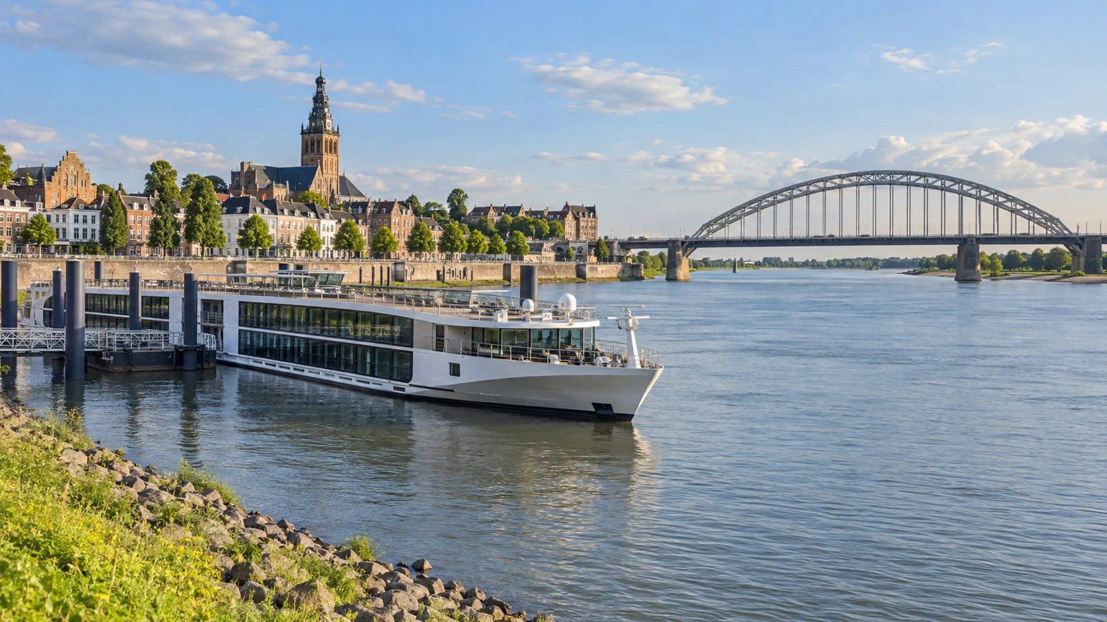 River cruise ship beside Nijmegen with the Waal River bridge in the background
