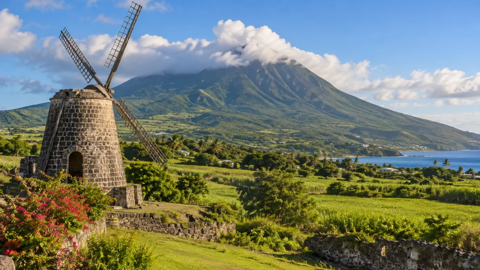 Historic sugar estate windmill below the green slopes of Nevis Peak