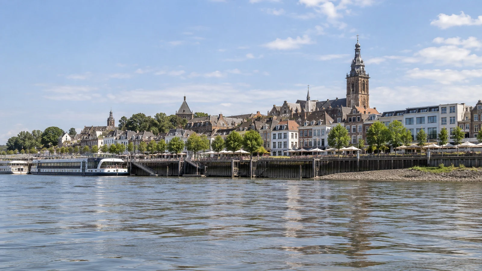 Nijmegen riverfront terraces and old town buildings viewed from the water