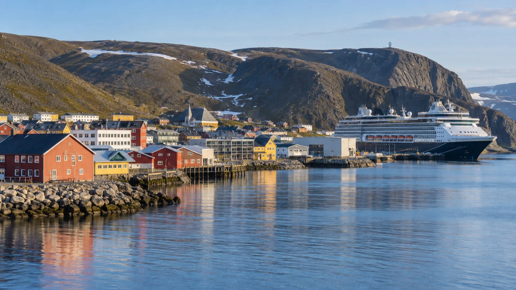 A cruise ship docked among colorful buildings in Honningsvåg, Norway
