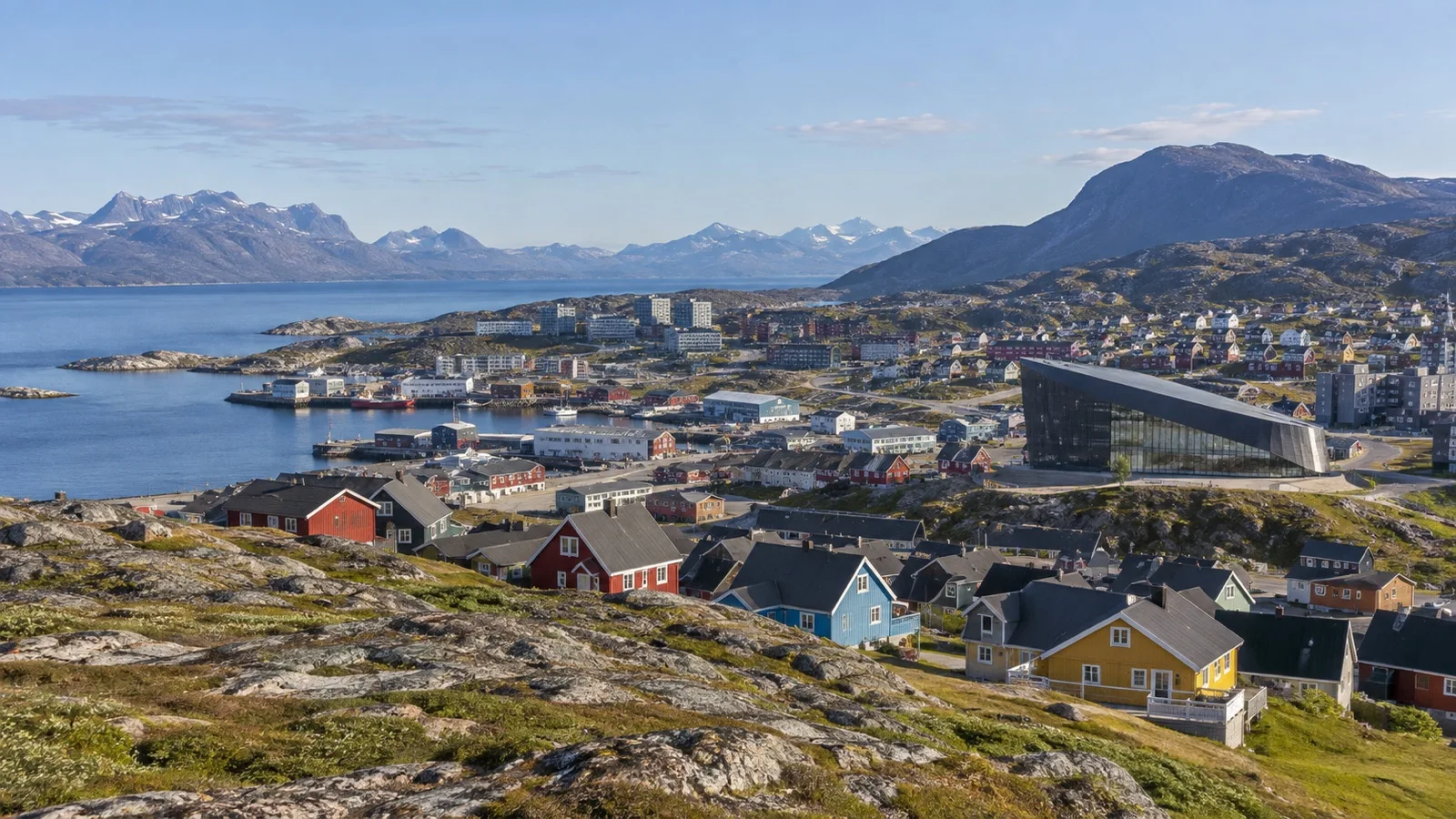 Colorful houses and waterfront buildings in Nuuk with the fjord beyond