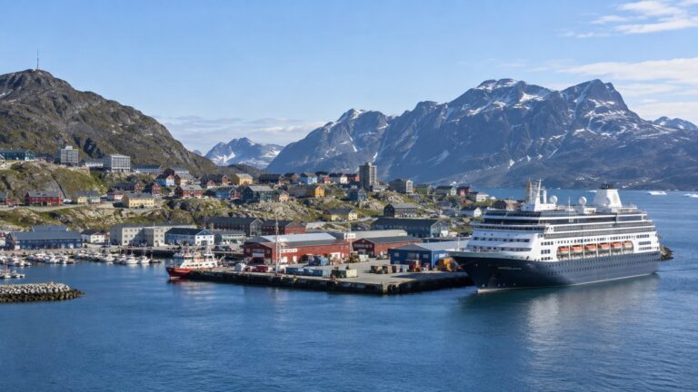 Cruise ship at Nuuk harbor with colorful buildings and Arctic mountains