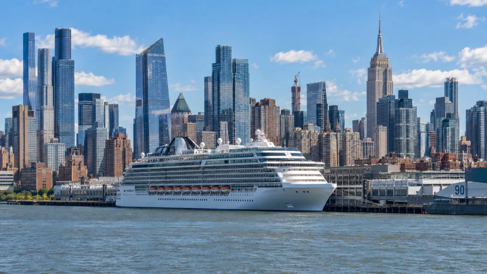 Cruise ship docked at the Manhattan Cruise Terminal on the Hudson River with Midtown behind