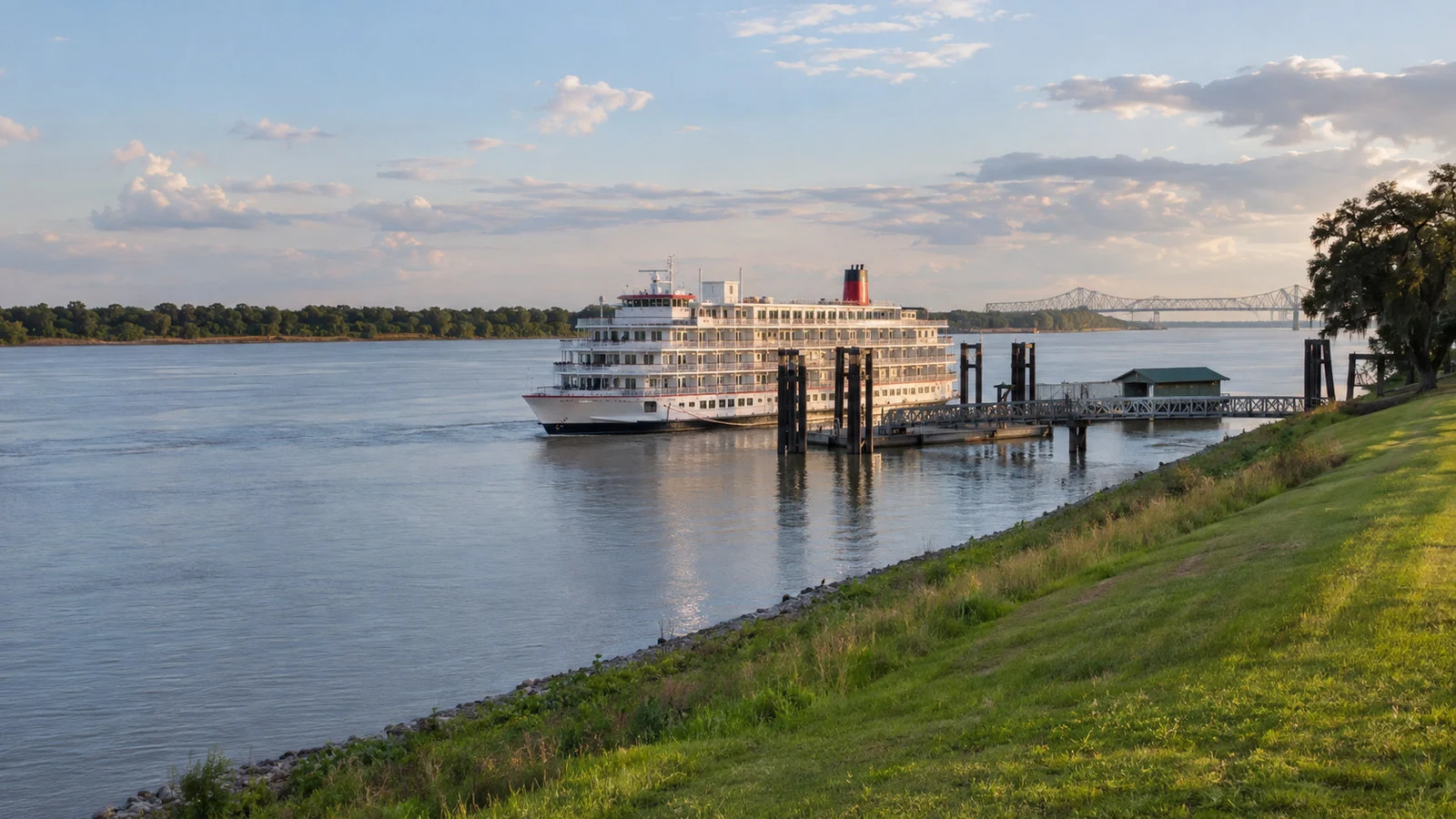 Mississippi River near Oak Alley Plantation Louisiana with river cruise vessel by a modest landing and levee, no people