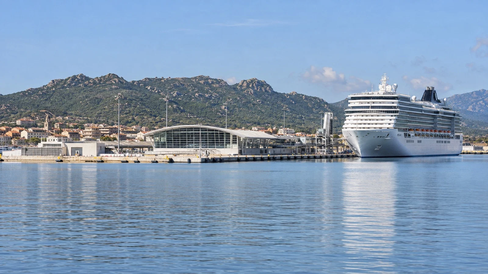 Cruise ship at Olbia Isola Bianca port with Sardinian hills beyond