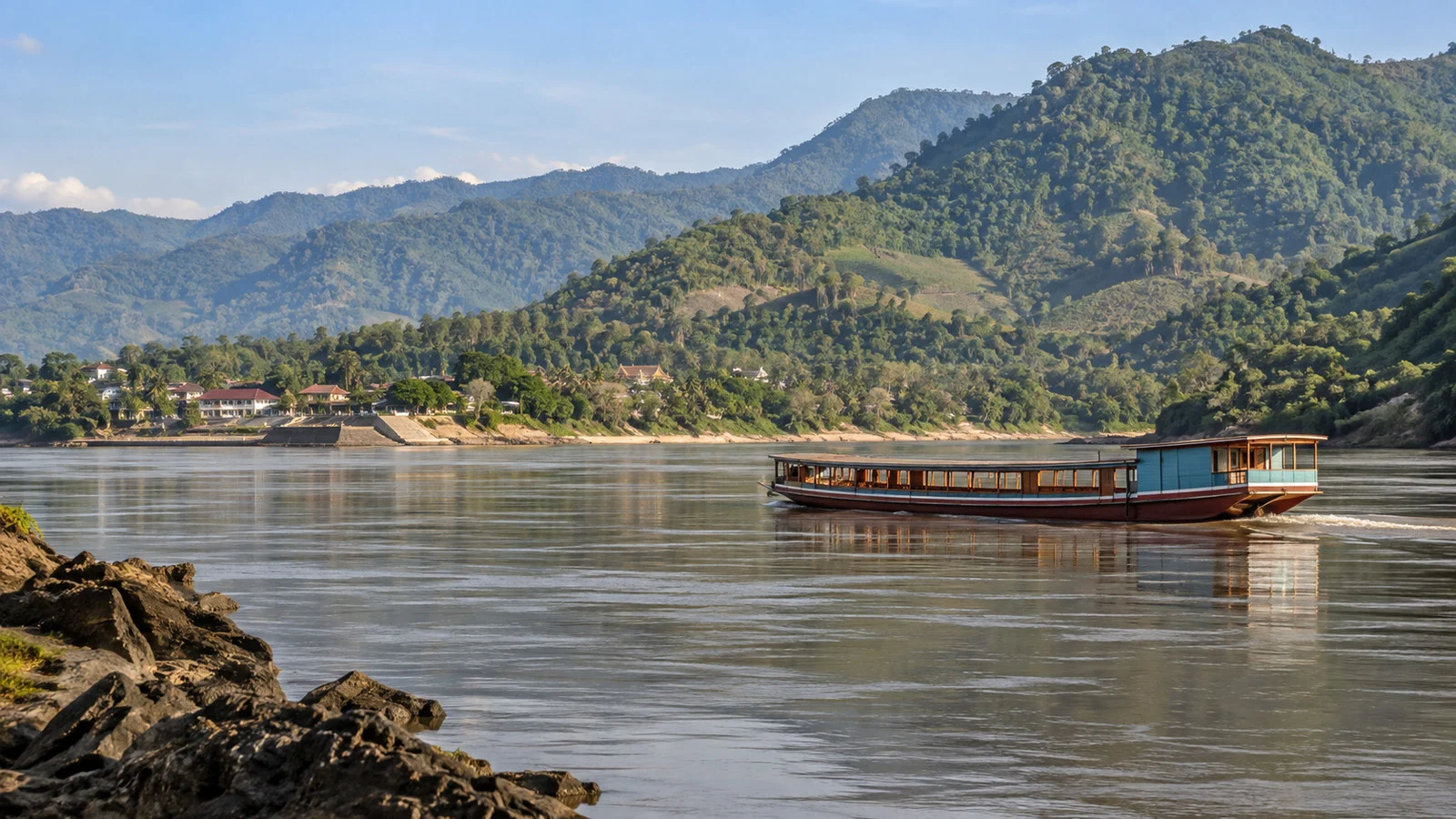 Mekong River hills and a passenger boat near Pak Lay