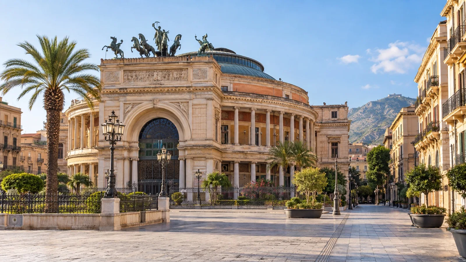 Palermo's Politeama neighborhood centered on the grand Teatro Politeama Garibaldi, nearby hotel buildings and sunny empty street