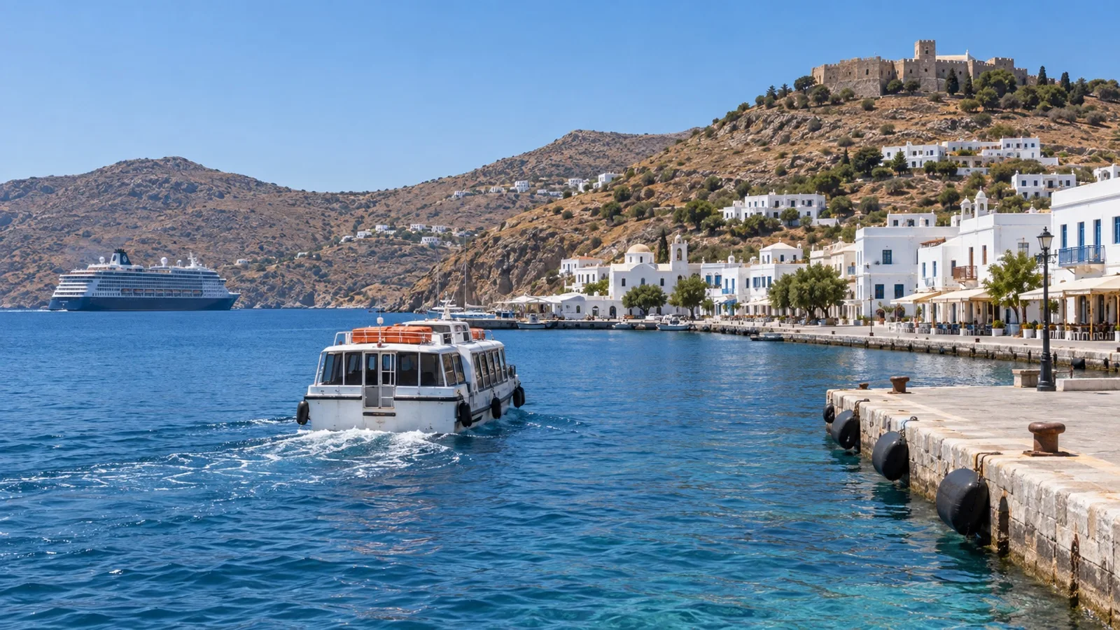 Cruise tender approaching Skala harbor on Patmos with a ship anchored offshore