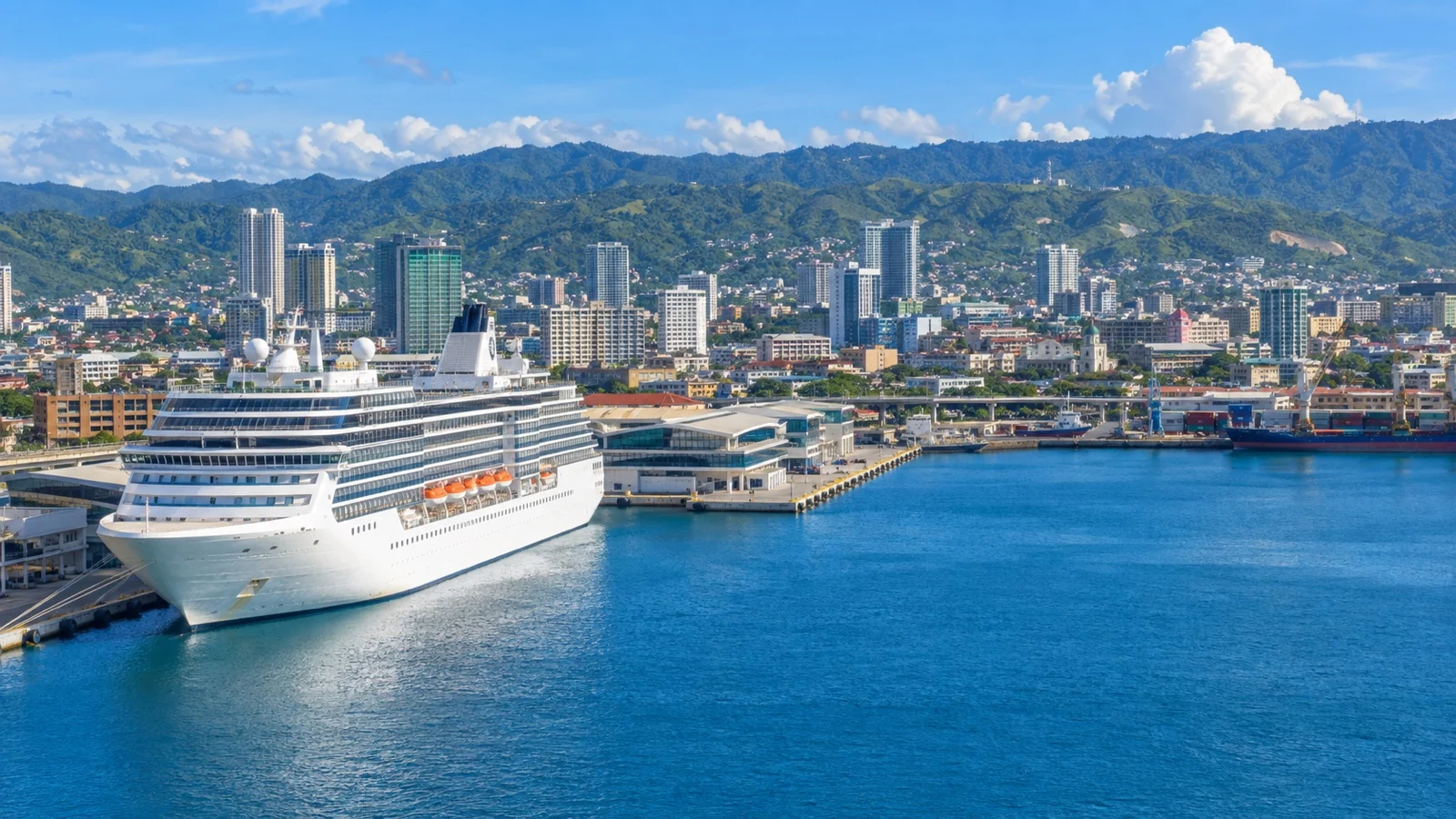 Cruise ship at Cebu harbor with city buildings and green hills beyond