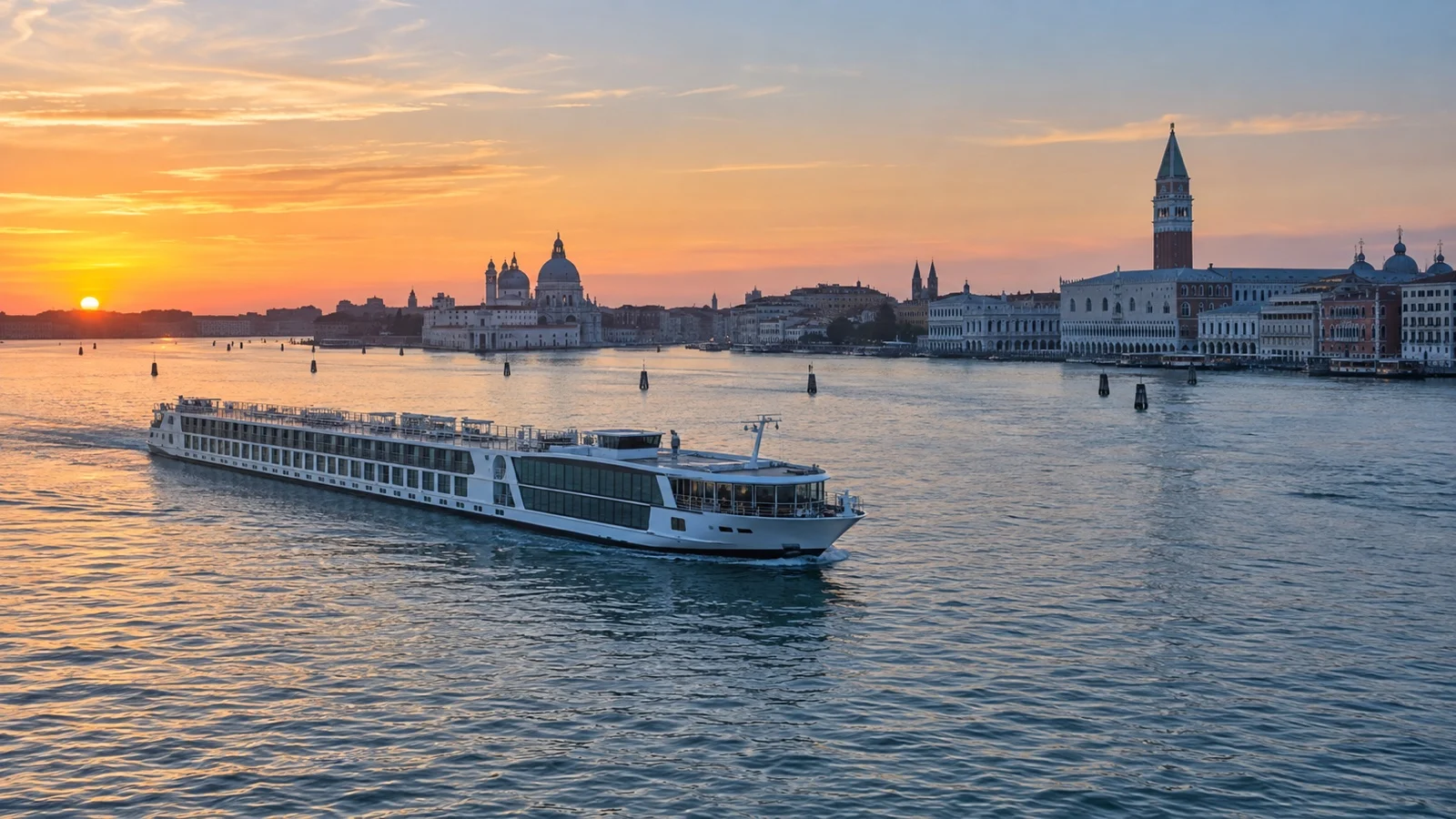 Small river cruise ship crossing the Venice lagoon near the historic waterfront