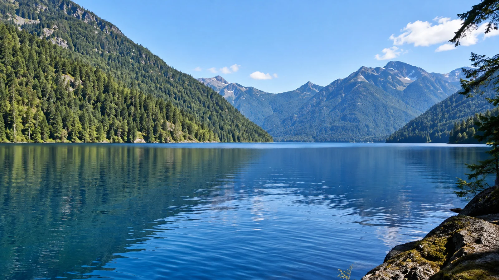 Lake Crescent in Olympic National Park Washington, clear deep blue glacial lake with conifer-covered mountain shores