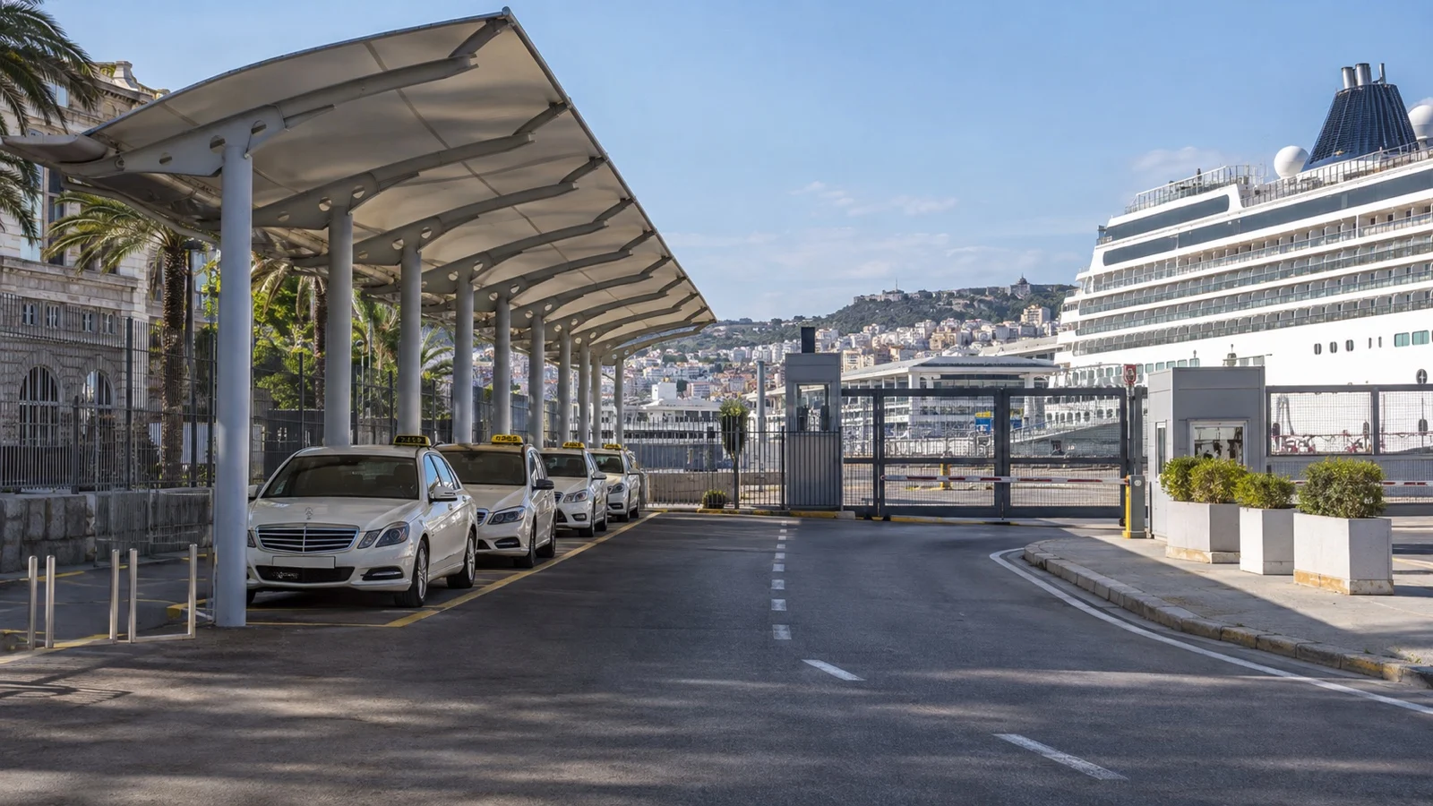 Empty taxi pickup lane beside a cruise port gate and docked ship