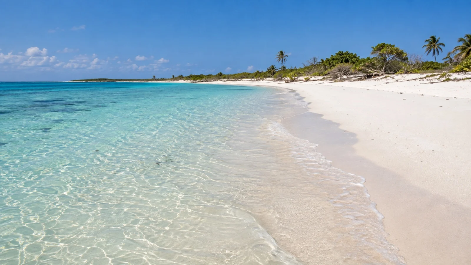 Empty white-sand beach and shallow blue water on Portuguese Island, Mozambique