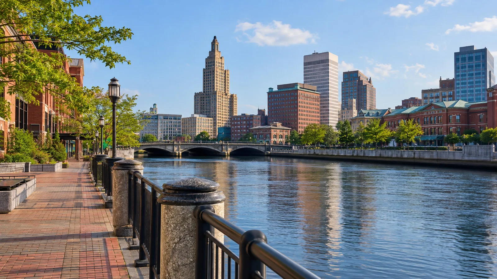 Waterfront route from India Street toward downtown Providence with river promenade and city skyline, no people