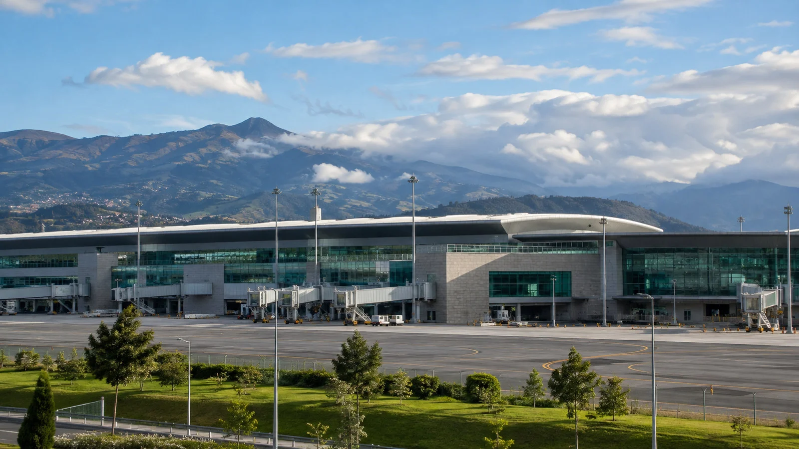 Exterior of Quito Mariscal Sucre International Airport terminal in Tababela with Andes hills behind, no readable signage