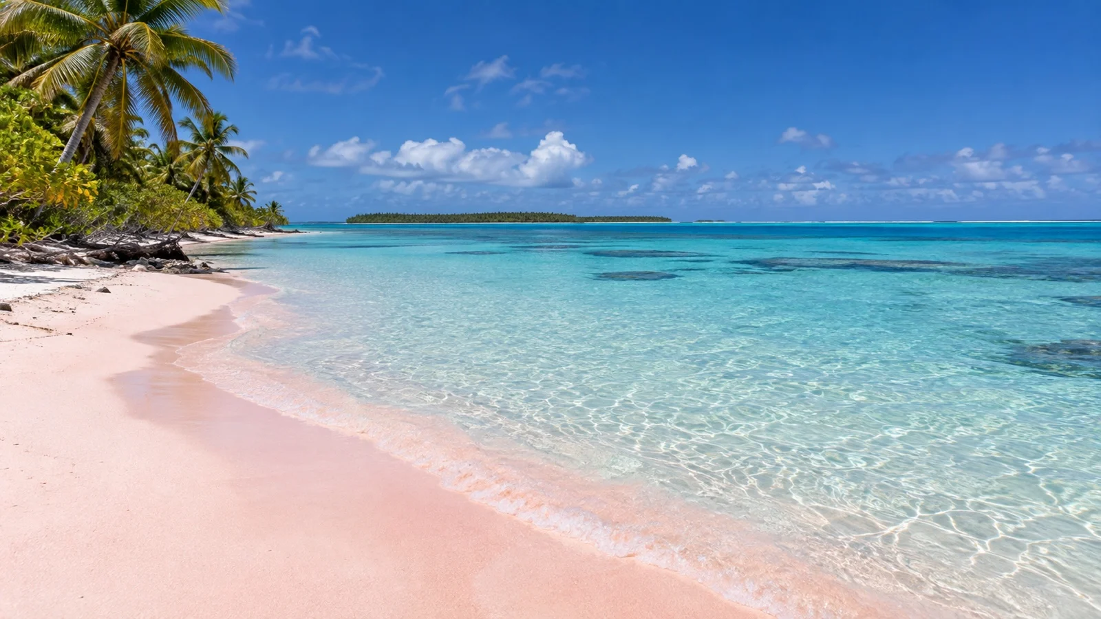 Empty pale pink sand beach and clear water on Rangiroa atoll