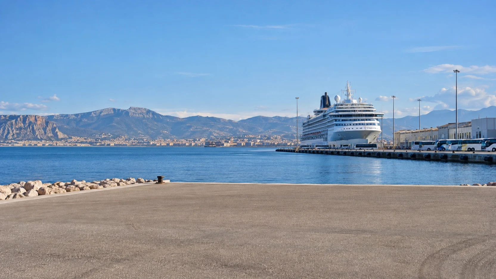 Cruise ship at a distant gateway port with an empty quay