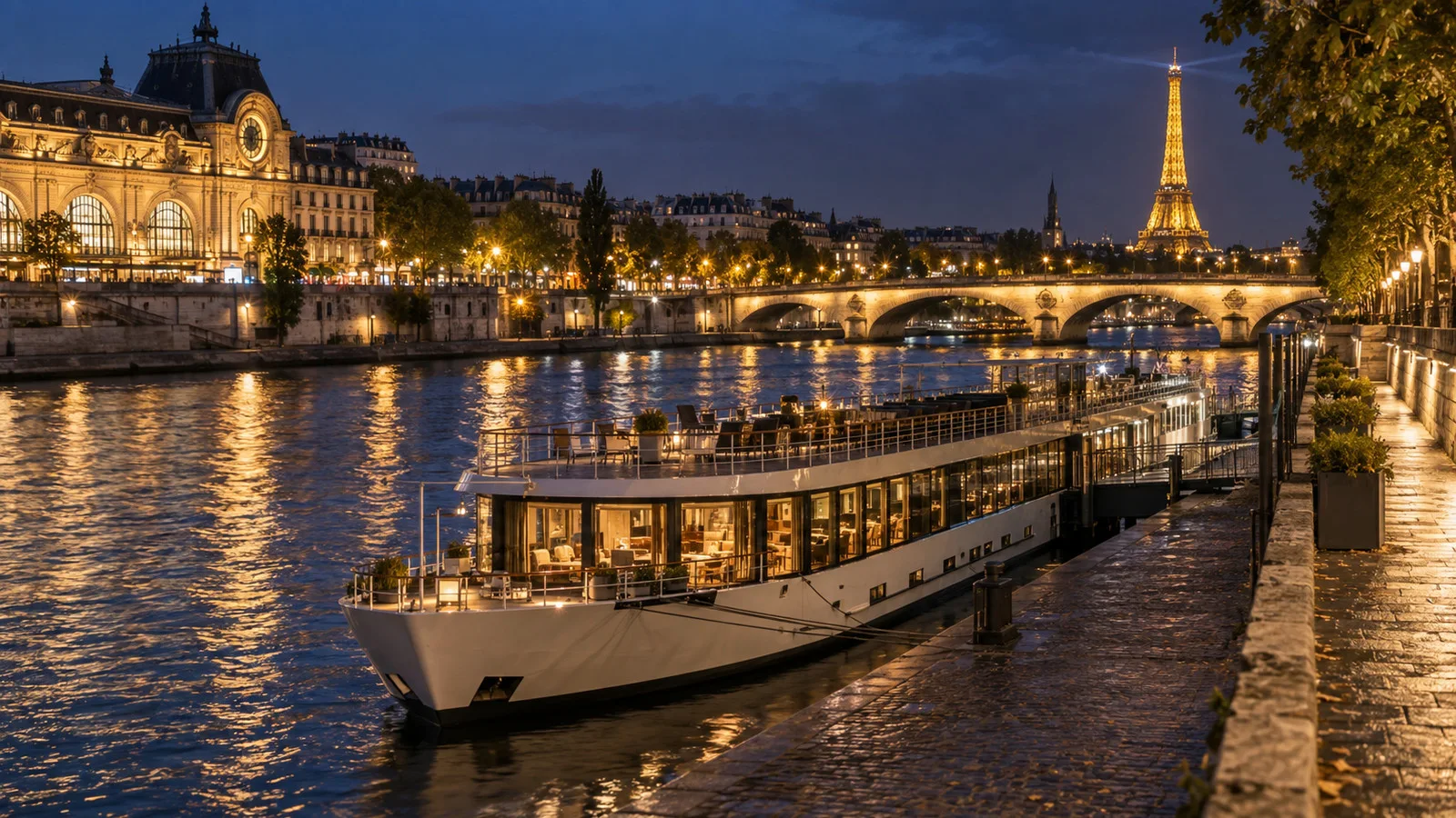 Paris Seine embankment at night with a moored river cruise ship and city lights