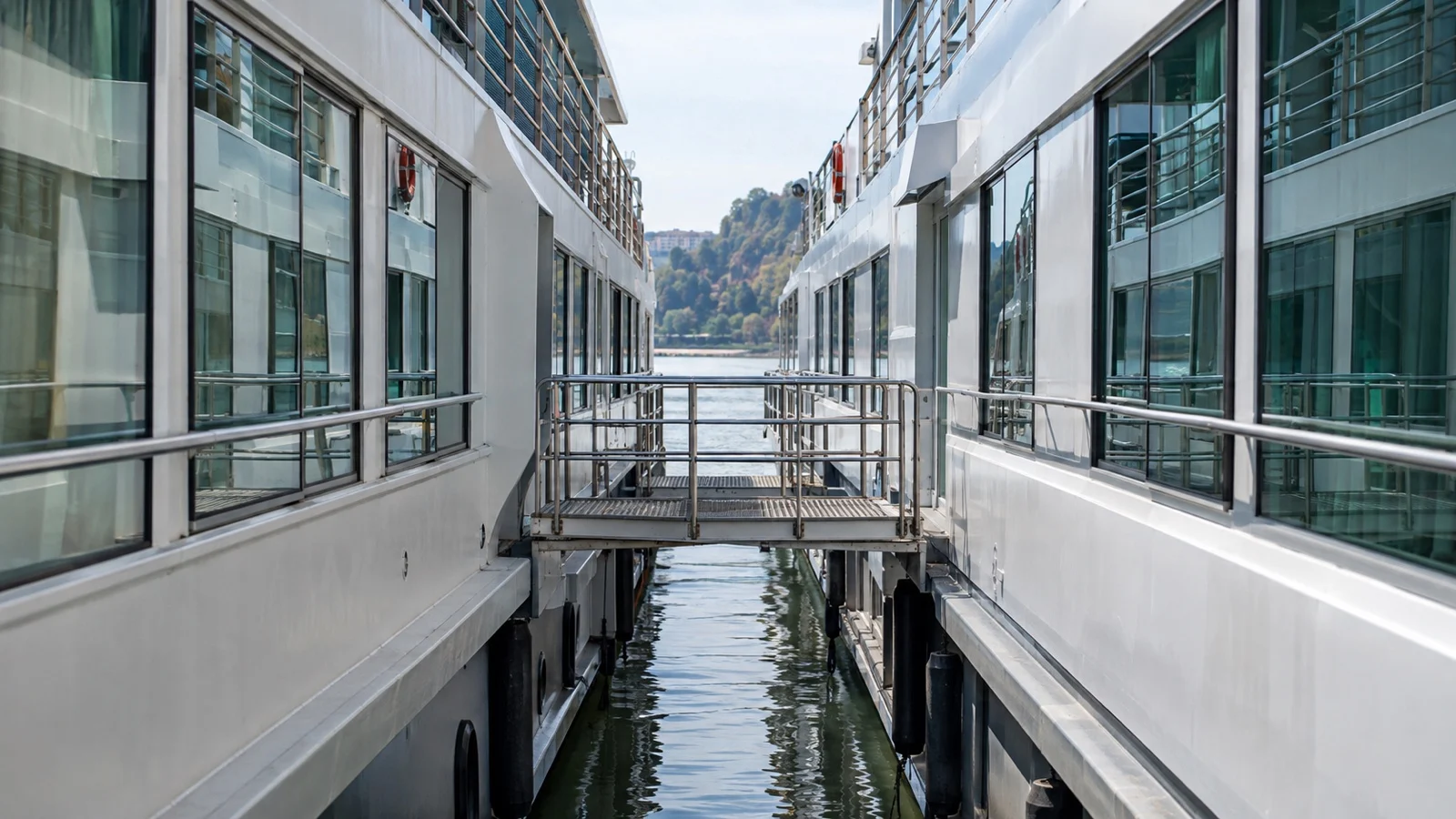 Close cabin windows of rafted river cruise ships