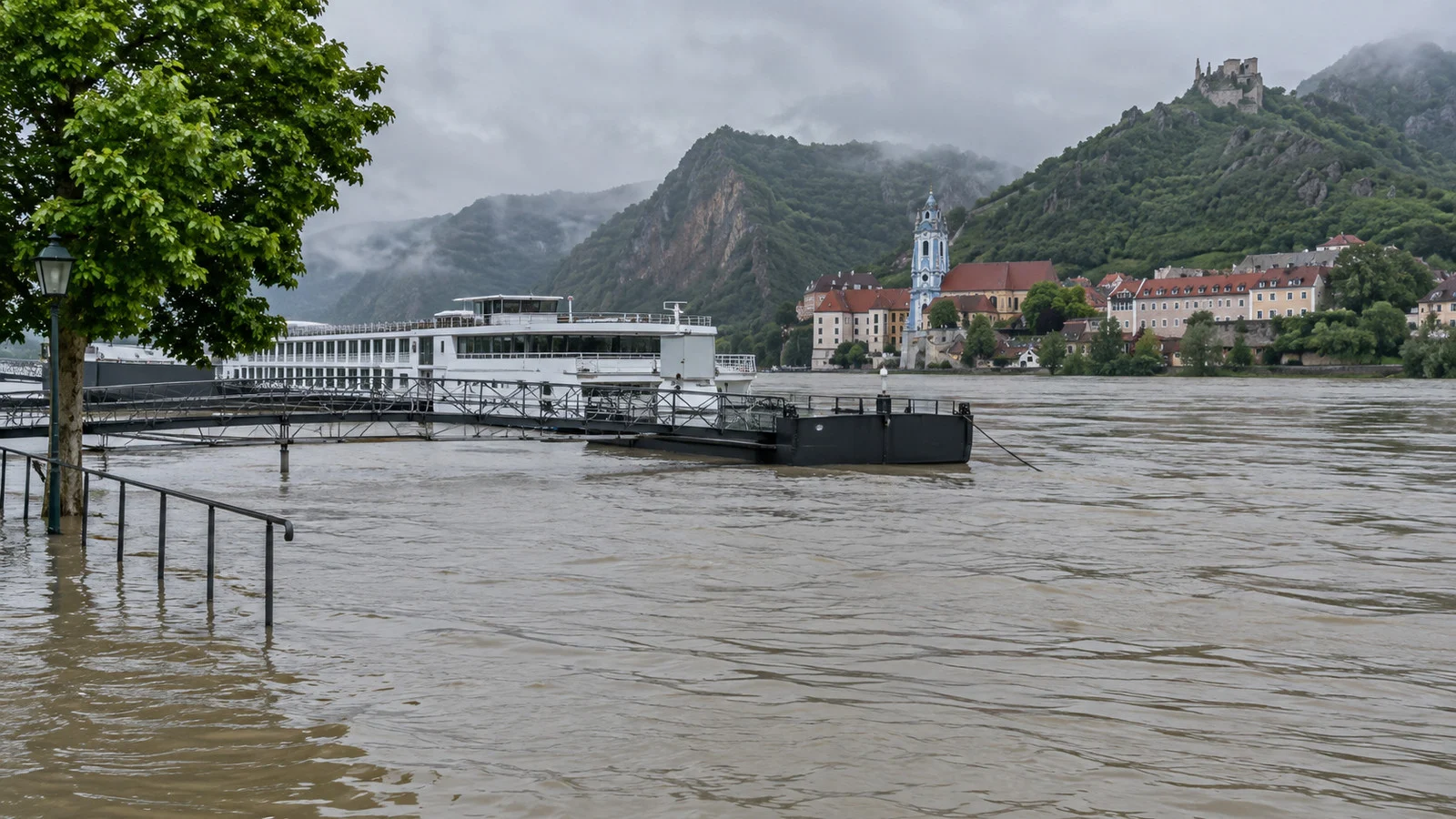 High Danube water near a river cruise landing after heavy rain