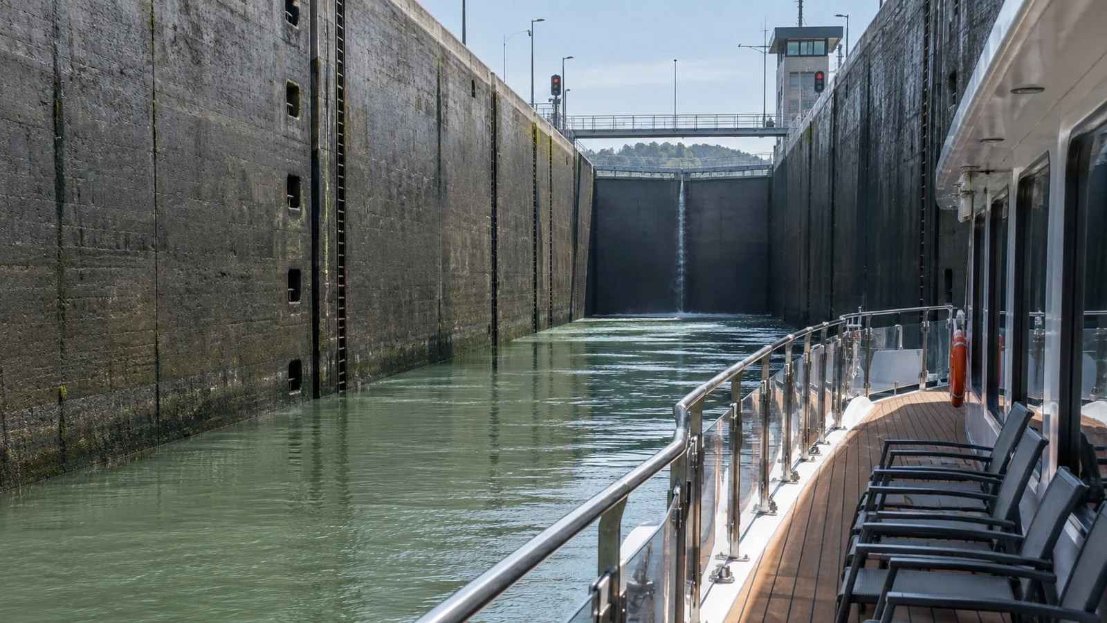 River cruise ship beside high lock walls