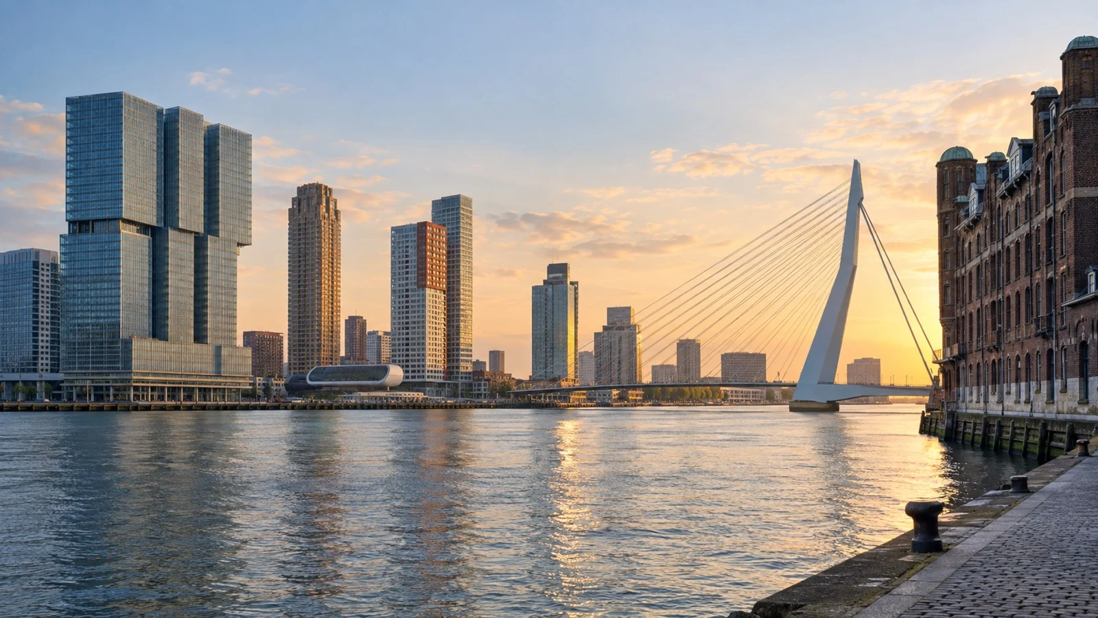 Kop van Zuid waterfront district in Rotterdam with modern hotels, historic warehouses and Erasmus Bridge