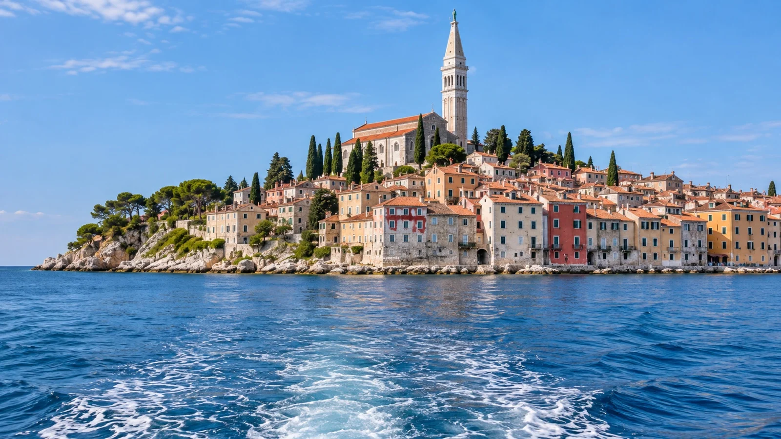 Tender boat approaching Rovinj old town across the Adriatic
