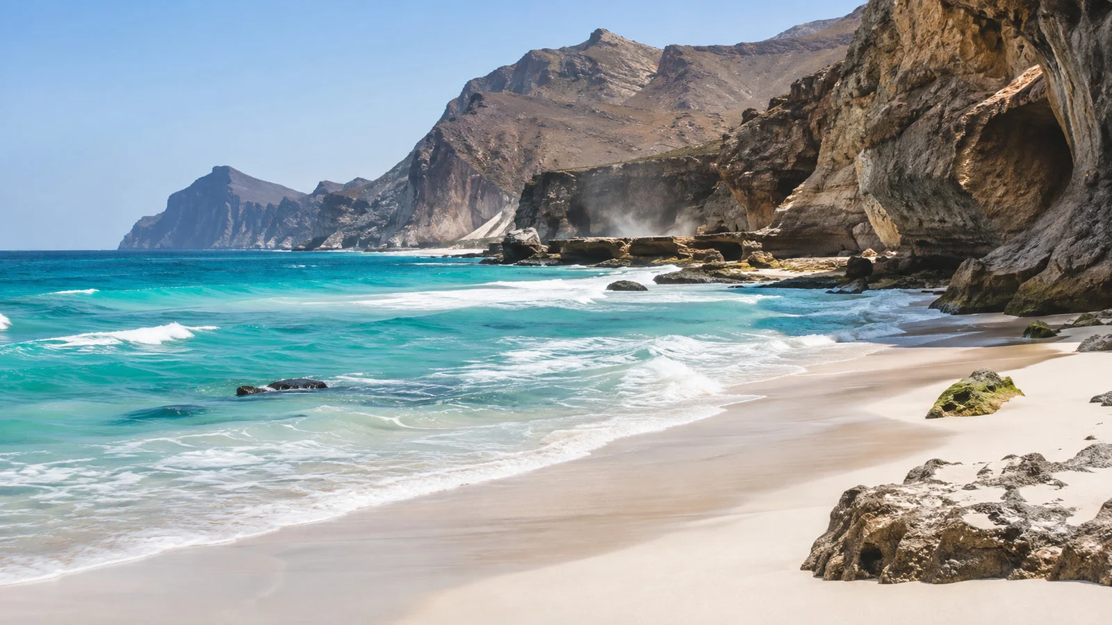 White sand and cliffs at Al Mughsail Beach
