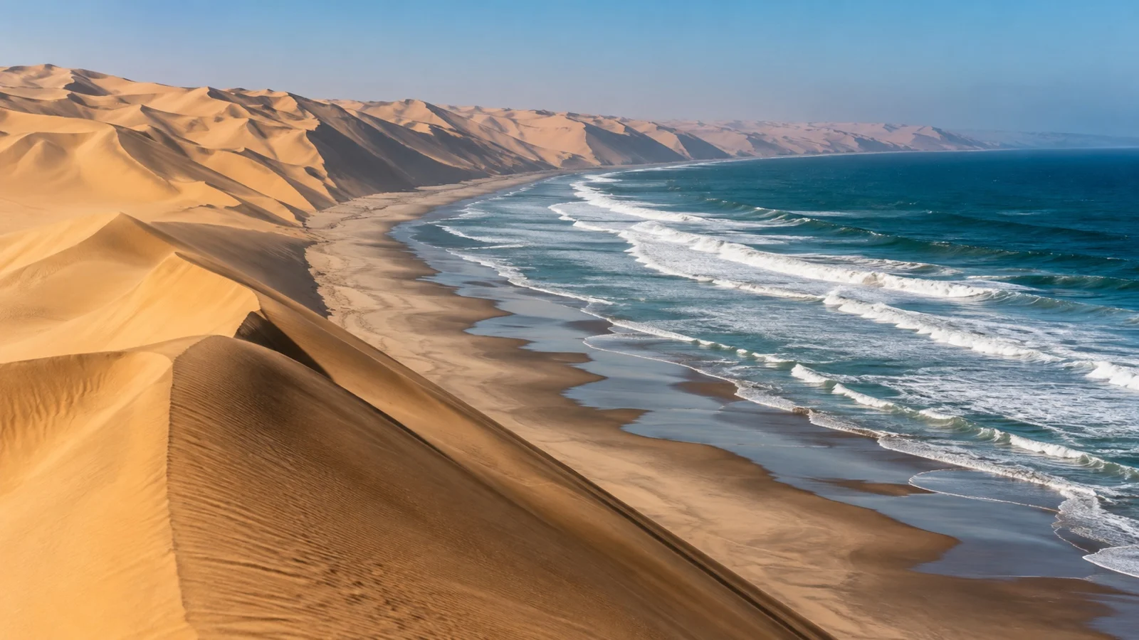Sandwich Harbour dunes descending to the Atlantic Ocean