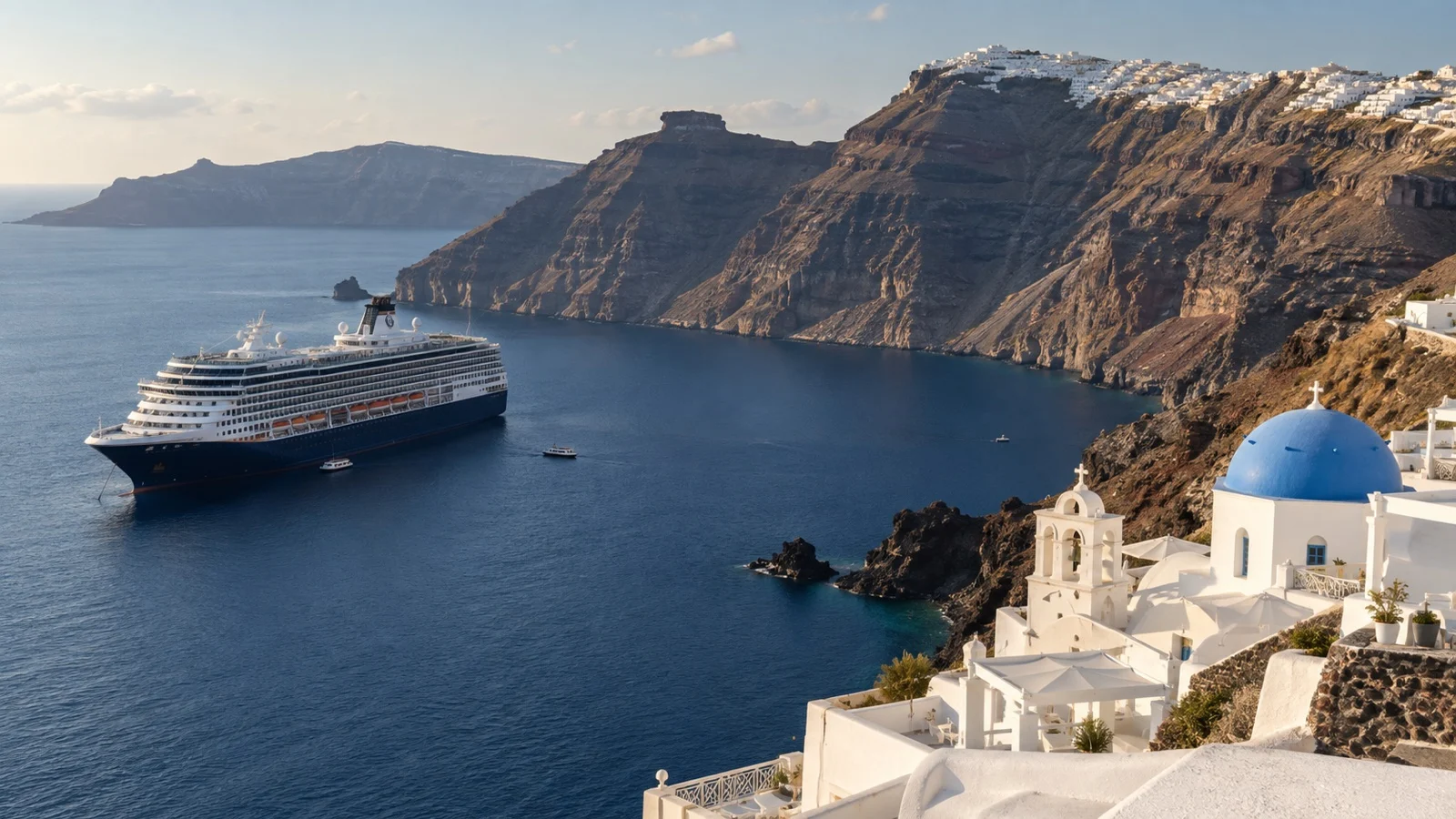 Cruise ship anchored in the Santorini caldera below white cliffside villages.