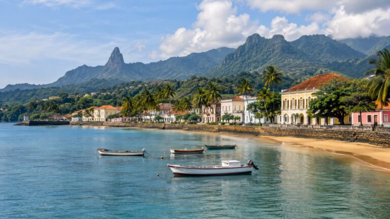 São Tomé waterfront with colorful buildings and green volcanic mountains