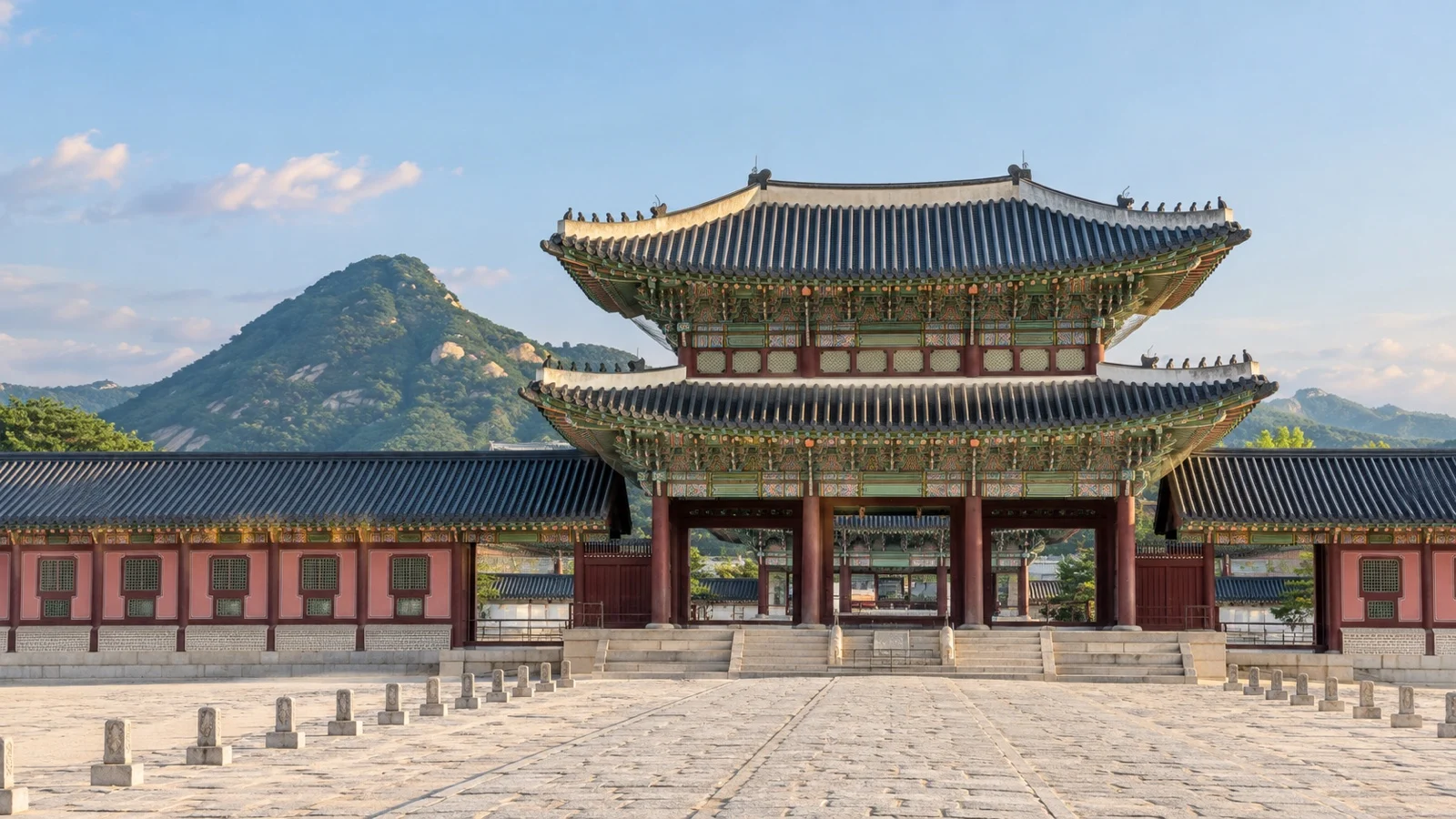 Traditional palace gate and mountain backdrop at Gyeongbokgung in Seoul