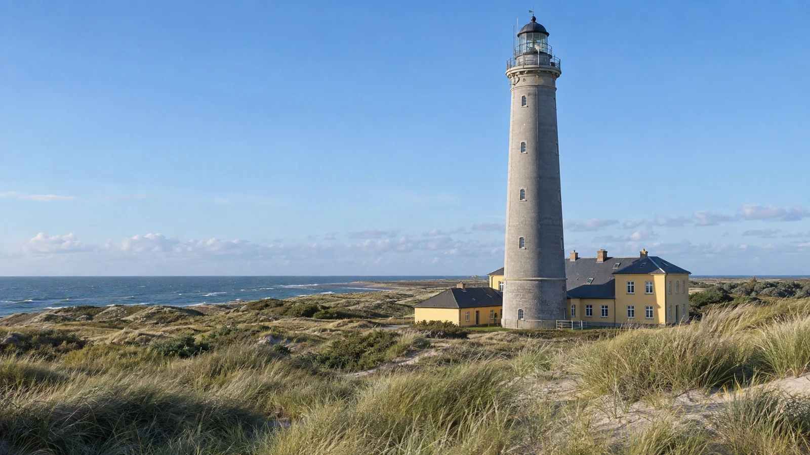 Gray Lighthouse above coastal dunes near Skagen