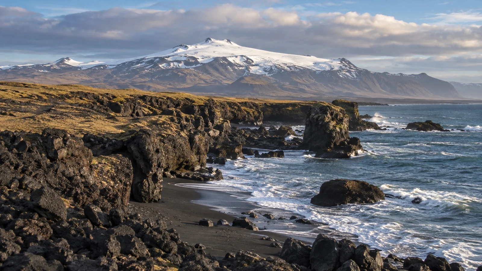 Volcanic Snæfellsnes coast with Snæfellsjökull glacier in the distance
