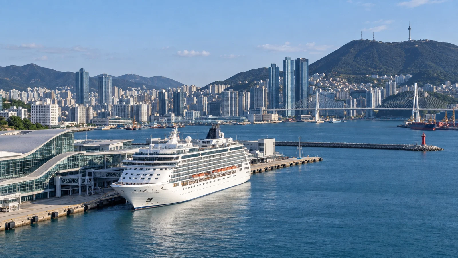 Cruise ship in Busan harbor with city skyline and coastal hills beyond