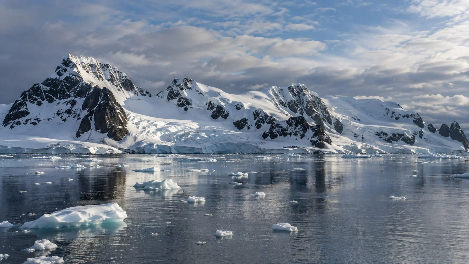South Shetland Islands snow-covered mountains and scattered sea ice under cold polar sky, no people